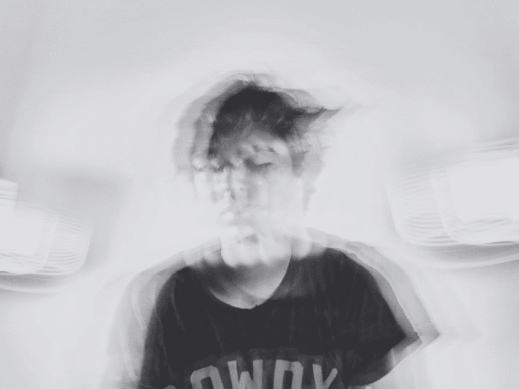 A person with ADHD and limerence. Black and white, moving image of a person.