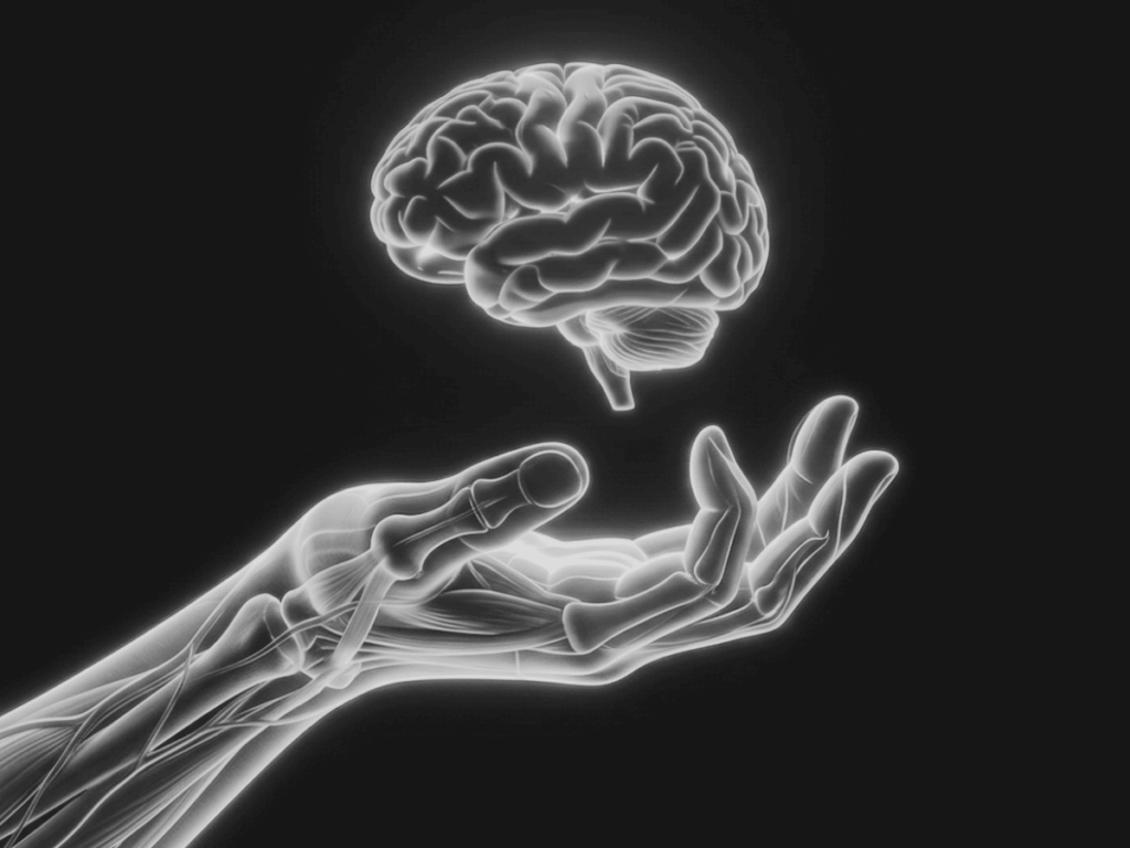Floating brain with hand underneath in black and white.